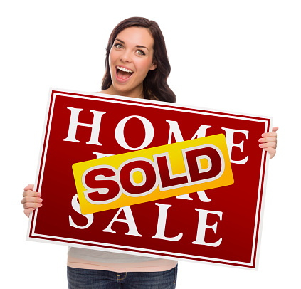 Happy Mixed Race Female with Sold Home For Sale Real Estate Sign Isolated on White.
