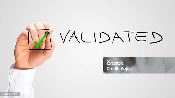 Hand Putting Check Inside Box For Validated Option Stock Photo - Download Image Now - Validation, Finishing, 2015