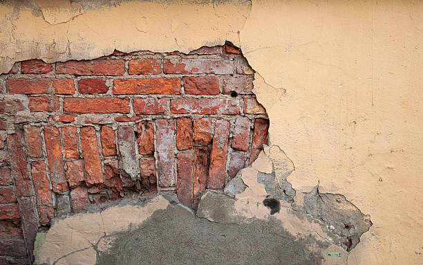 istock Texture of old wall covered with yellow stucco 536687073
