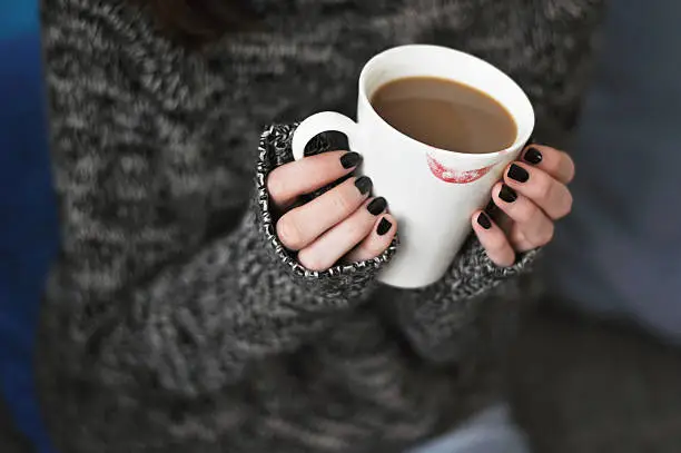 Photo of Holding a cup of coffee