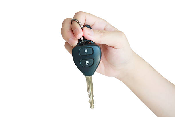 istock Hand holding car key isolated on white background 536687642