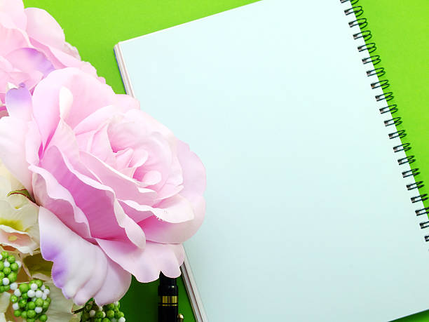 istock open notebook and beautiful pink roses artificial flowers bouquet 536687692
