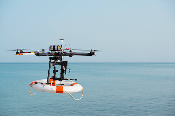 Flight of rescue drone carrying lifebuoy. stock photo