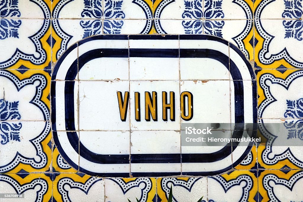 Tile signboard "WINE" in Lisbon Detail of an Azulejo (wall tile) outside a restaurant  in Lisbon, Portugal Wine Stock Photo