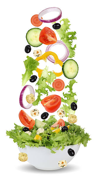 istock Falling ingredients for green salad in bowl with lettuce, tomatoes 536722549