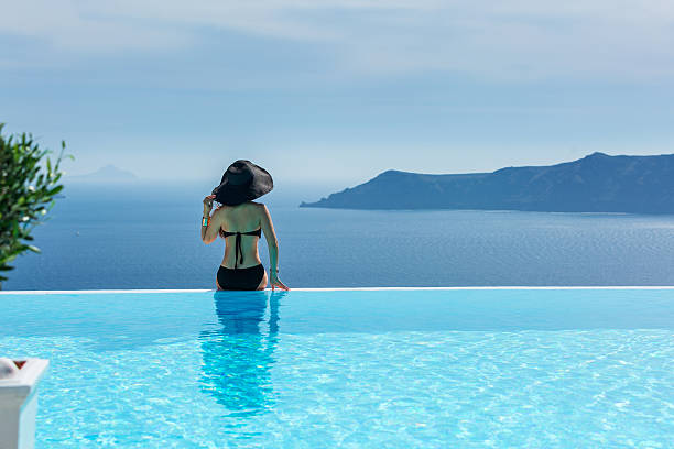 istock Woman in a black bathing suit and a hat 536722584