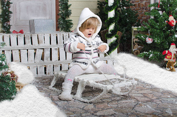 istock child on sled in yard of winter snow 536722639