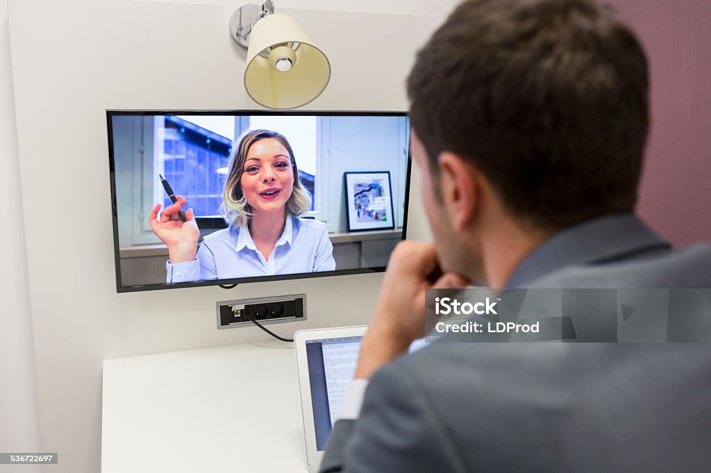 Businessman on video conference with her colleague in office job Business people computer screen man woman desk Watching Stock Photo