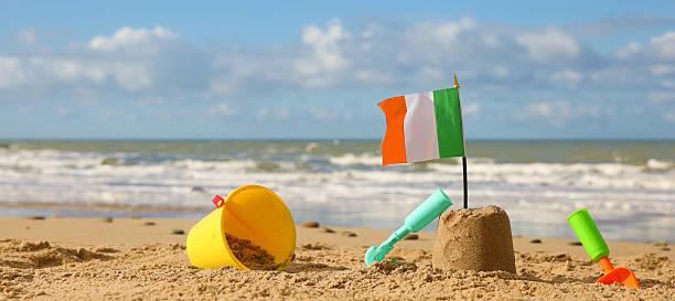 istock Beach, sea with bucket, rake, spade, sandcastle and Irish flag 536724385