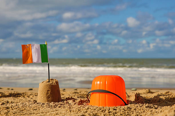 istock Beach, sea with orange bucket, sandcastle and Irish flag 536724399