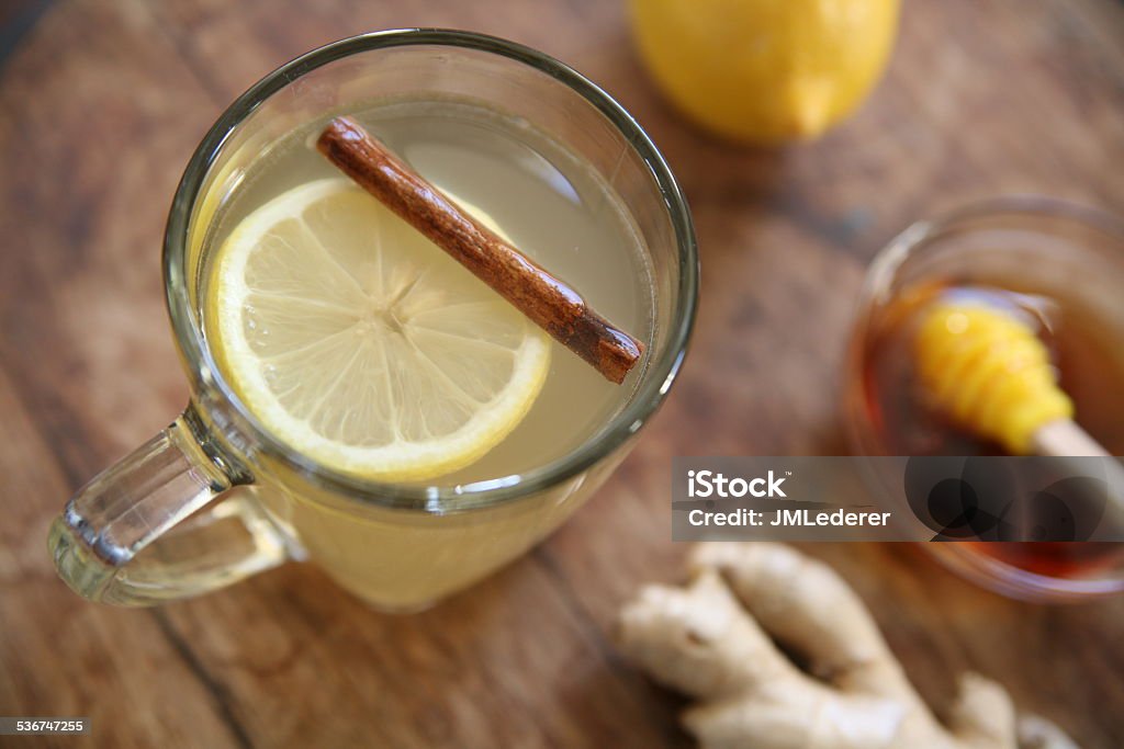 Hot toddy Top down shot of hot whiskey toddy drink with lemon, honey, cinnamon, and ginger. Hot Toddy Stock Photo