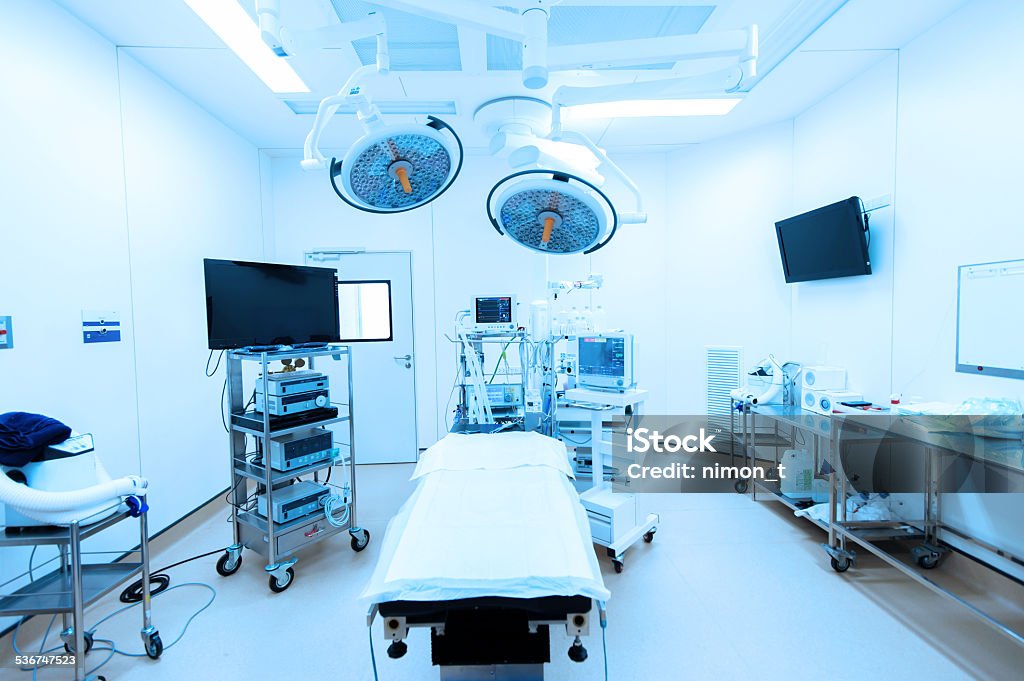 medical devices in modern operating room take with blue filter equipment and medical devices in modern operating room take with blue filter Operating Room Stock Photo