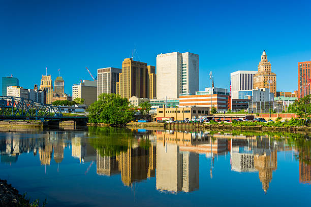 Newark downtown skyline and reflection on Passaic River Newark downtown skyline with a mirror like reflection on the Passaic River in the foreground. essex stock pictures, royalty-free photos & images
