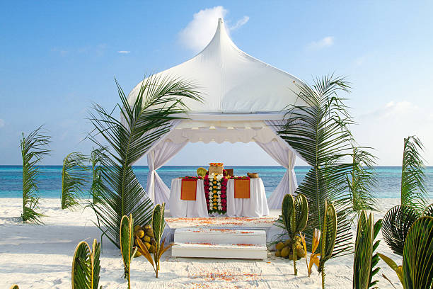 Beach Wedding Pavilion by the Ocean Paradise Beach Wedding Ceremony Location by the Ocean. Wonderfully decorated with tropical Flowers and Heart Shaped Palm Leafs, this image was taken in a luxury Maldives Resort maldivian culture stock pictures, royalty-free photos & images