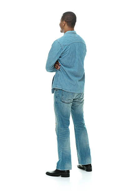 istock Rear view of man standing with arms crossed 536748139