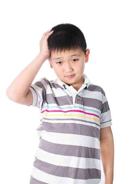 istock Boy having a headache holding his head with his hand 536749401