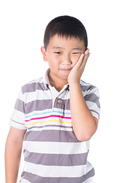 istock Boy having a toothache holding his face with his hand 536749997