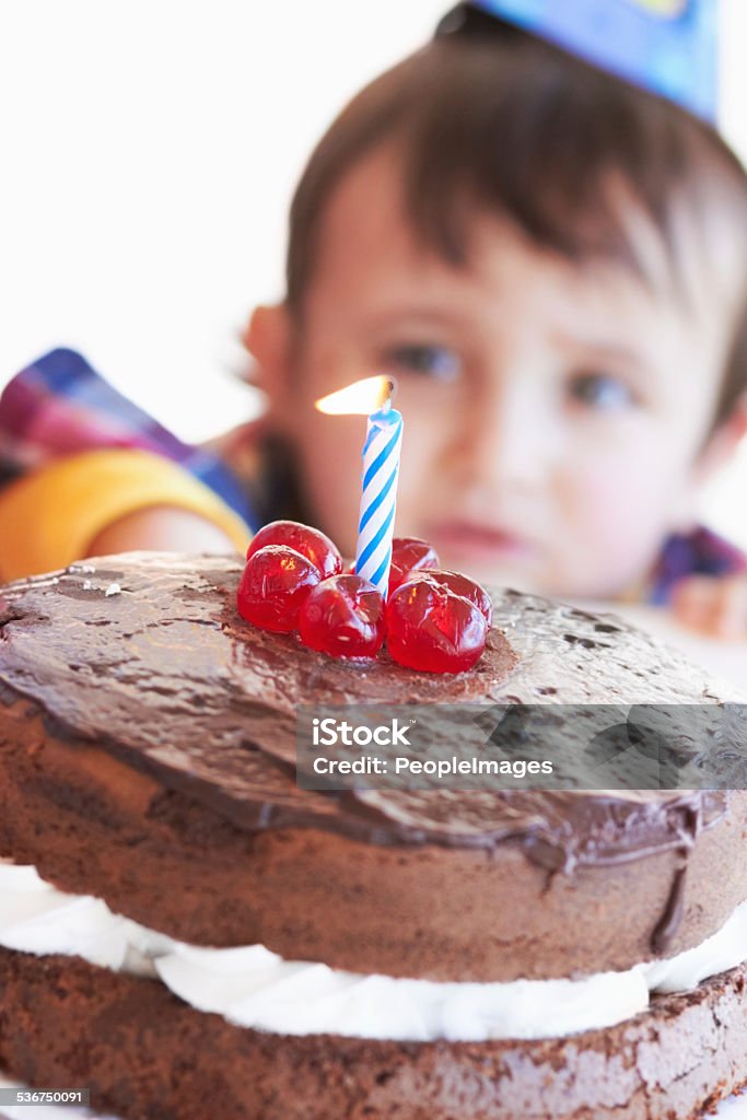 Celebrating a special day A birthday cake with one candle with the birthday boy in the backgroundhttp://195.154.178.81/DATA/istock_collage/374098/shoots/781089.jpg 2-3 Years Stock Photo