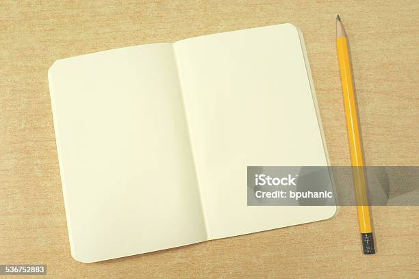 Blank Open Notebook And Yellow Pencil On Brown Desk Stock Photo - Download Image Now