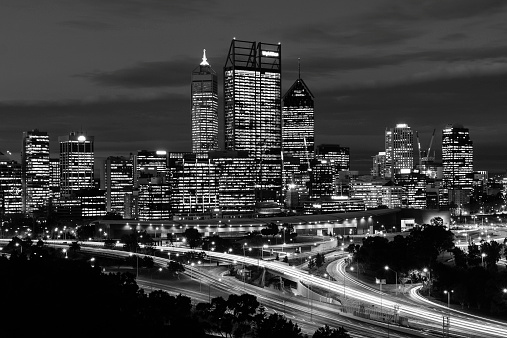 Perth city skyline at night shot from across the Swan river in black and white.
