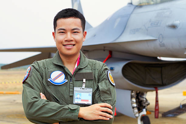I'm an fighter ace! A shot of a confident asian fighter pilothttp://195.154.178.81/DATA/istock_collage/1169306/shoots/781587.jpg air force stock pictures, royalty-free photos & images