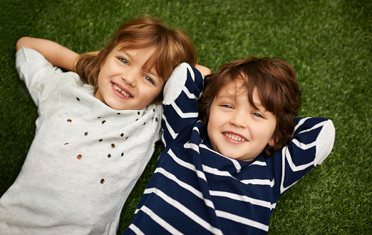 Brother and sister relaxing on the grass in the backyardhttp://195.154.178.81/DATA/istock_collage/1160002/shoots/783959.jpg