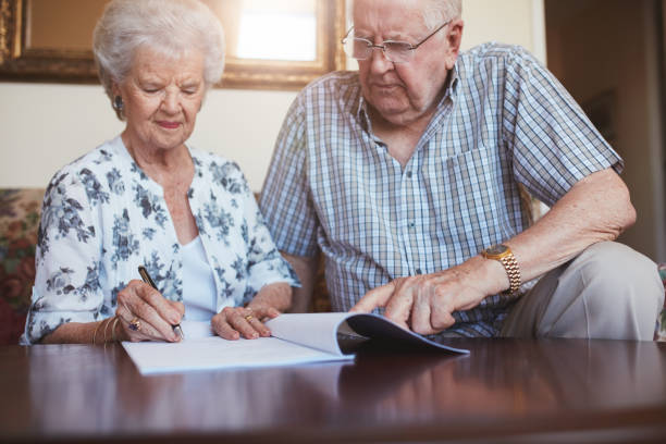 istock Senior husband and wife doing paperwork together at home 536753762