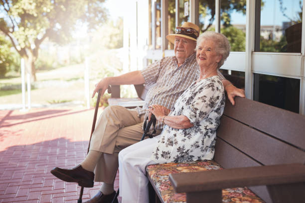 istock Retired couple sitting on a bench outside their home 536757220