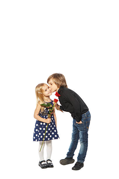Portrait of well-dressed children, boy kissing a girl