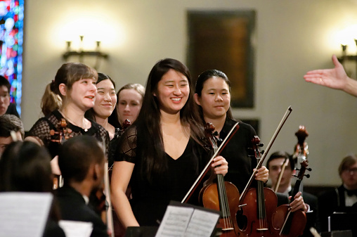 Philadelphia, PA, USA - February 1, 2015; Members of the Philadelphia Sinfonia youth orchestra string section stand up to receive applause during a performance at the First Presbyterian Church in the Germantown neighborhood of Philadelphia. (Photo by Bas Slabbers)