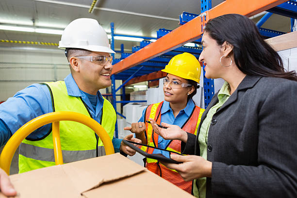istock Hispanic workers in warehouse talking with female supervisor 536773869