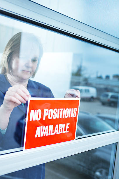 istock Business Owner Posting NO POSITION AVAILABLE sign in Recession 536775541
