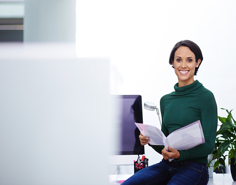 Portrait of a beautiful businesswoman looking through a file in the officehttp://195.154.178.81/DATA/istock_collage/1163382/shoots/784051.jpg