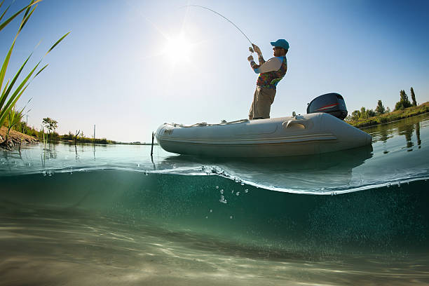 Fishing. Fisherman on the boat. Underwater view stock photo