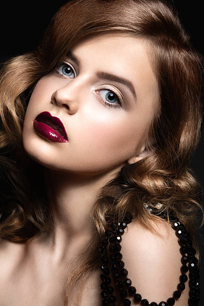 istock Beautiful woman with evening make-up, red lips and curls. 536776655