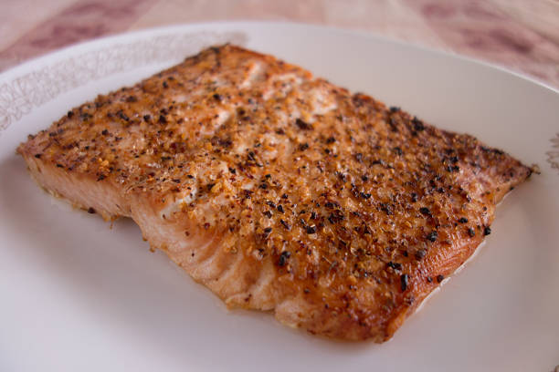 istock Broiled salmon with spices on white plate 536776737
