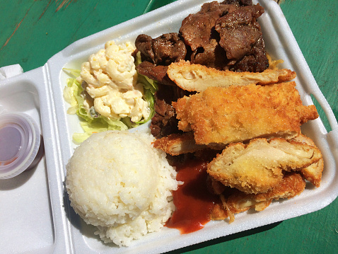 A Hawaiian specialty takeout fast food, the plate lunch includes teriyaki beef, chicken katsu, macaroni salad, and rice.