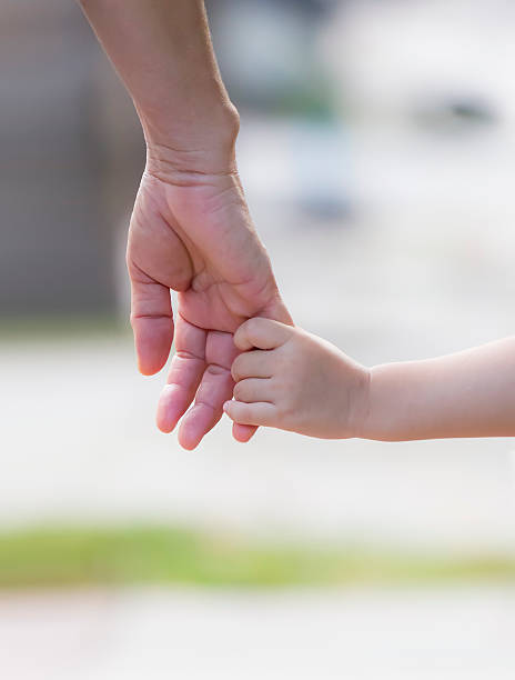 istock Mother lead child with hand by hand. 536777793