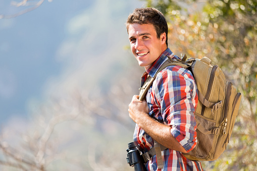 young man standing on top of the autumn mountain