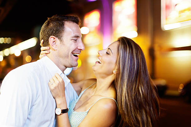 istock Laughing couple embracing in nighttime street 536809177