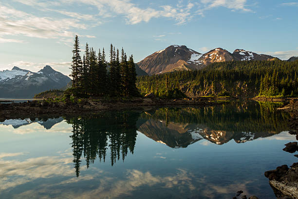 Mt. Price, in Garibaldi Provincial Park Mt. Price and nearby islands are reflected in the still water of Lake Garibaldi, in Garibaldi Provincial Park, British Columbia, Canada garibaldi park stock pictures, royalty-free photos & images