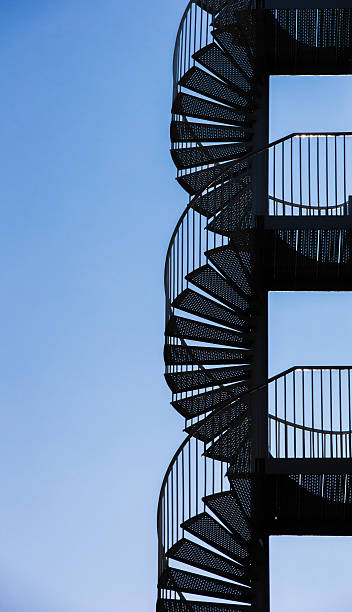 istock Spiral staircase against a blue sky 536809403