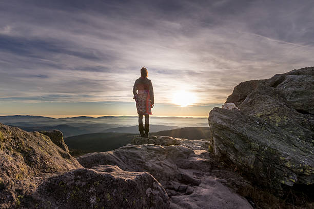 istock Woman on mountain at sunset 536809667