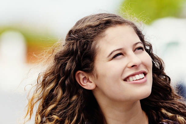 istock Curly-haired beauty smiling in the breeze 536810579