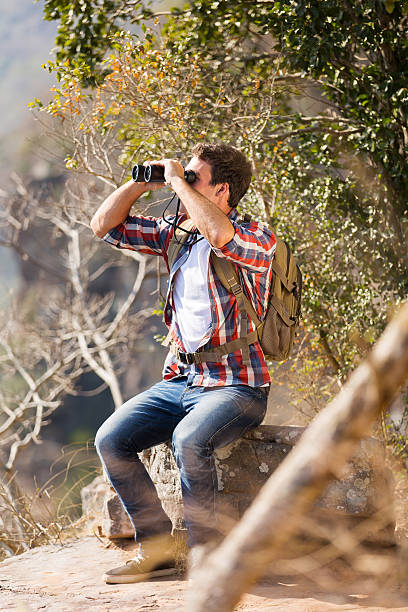istock young man sitting on top of the mountain 536811617