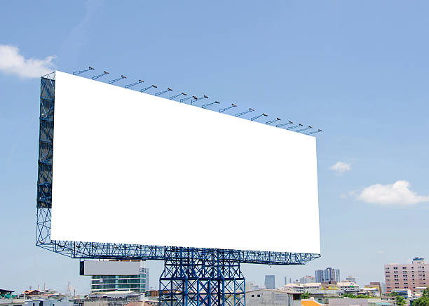 istock large blank billboard on road with city view background 536812403