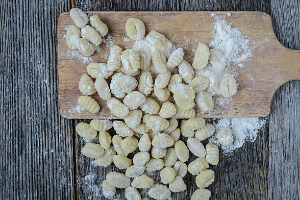 istock Gnocchi on Cutting Board and Rustic Wood Background 536812449