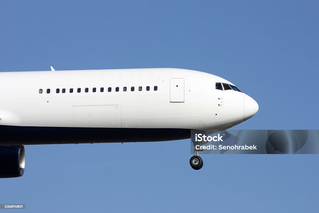 Aircraft nose Nose of huge white airplane landing on blue sky Air Vehicle Stock Photo