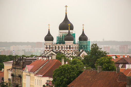 Facade of old Russian Orthodox church with bells on crosses on top of domes located on Cathedral Square of Moscow Kremlin