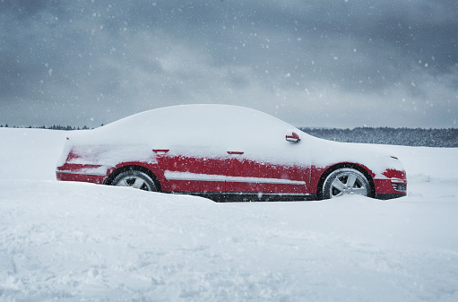 Winter, close up of red car covered with the snow